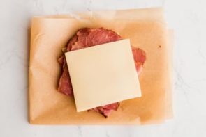 corned beef and swiss on a piece of parchment paper