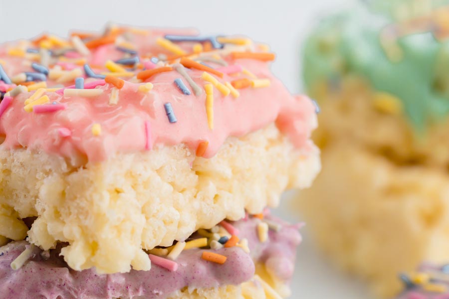 pink white chocolate frosting dripping down a keto rice crispy treat