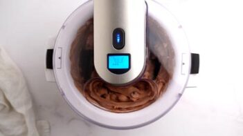 An ice cream maker churning chocolate ice cream.