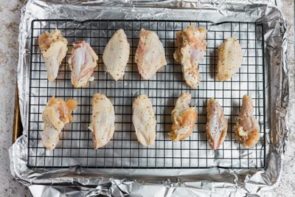 party wings on a tray lined with foil and a rack