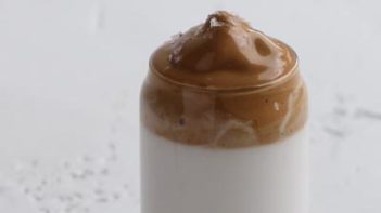 layers a salted caramel whipped topping on a coffee drink