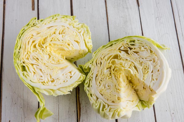 two heads of cabbage sliced in half