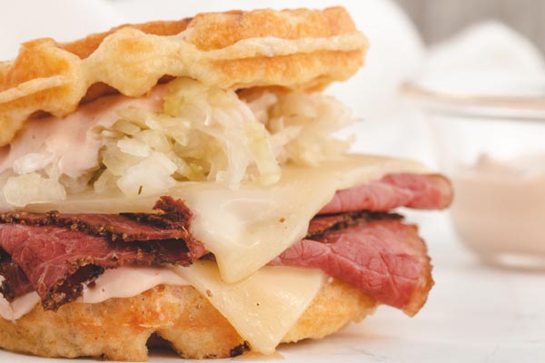 a reuben sandwich with cheese and corned beef