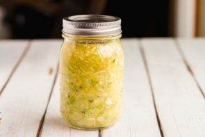 a jar of sauerkraut fermenting on the table