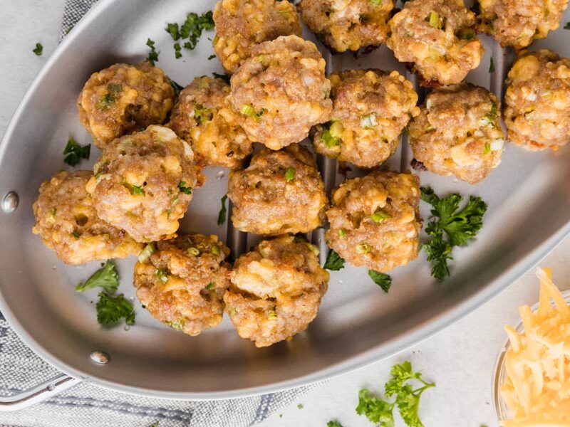 sausage bites on a skillet with parsley sprinkled around