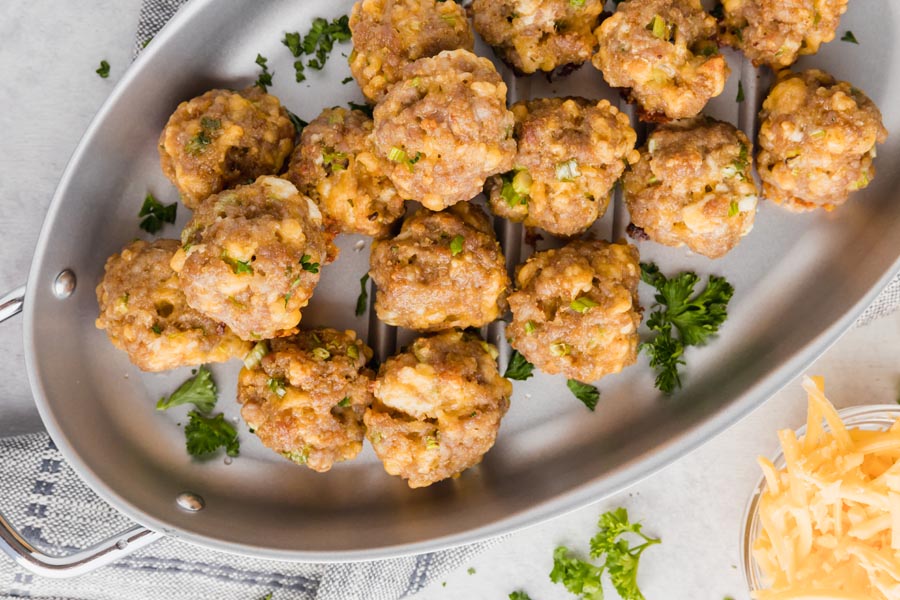 sausage bites on a skillet with parsley sprinkled around