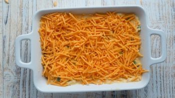 cheddar cheese sprinkles on top a casserole dish