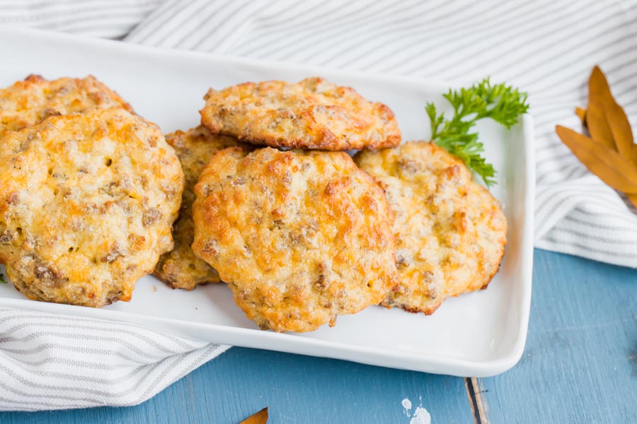 a white plate of keto biscuits filled with cheese and sausage