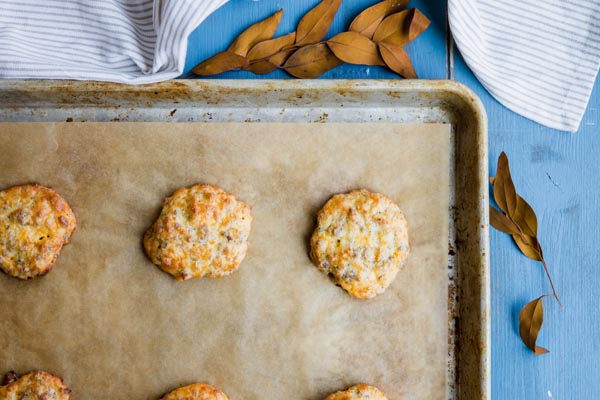 a bunch of sausage biscuits cooling on a baking tray