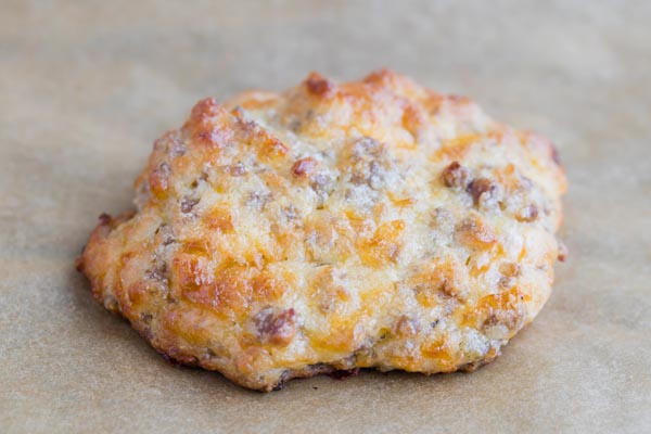 up close on a thick, cheesy sausage biscuit