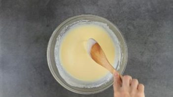 stirring biscuit batter in a bowl