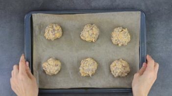 sausage biscuits on a parchment lined baking tray