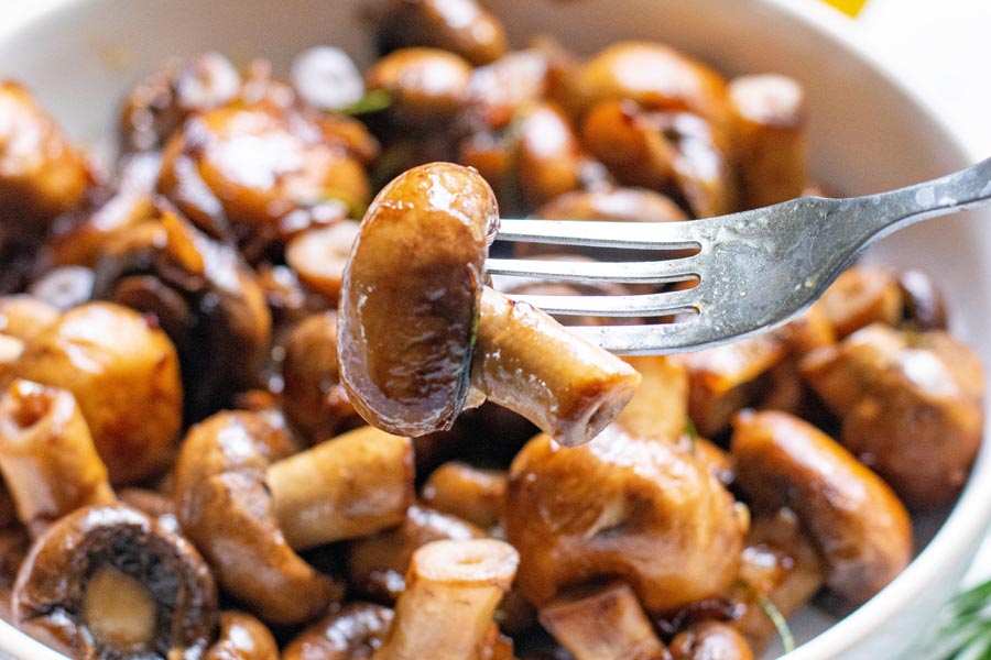 picking up a mushroom with a fork