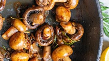 rosemary leaves mixed in with cooked mushrooms