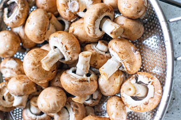 whole mushrooms in a colander