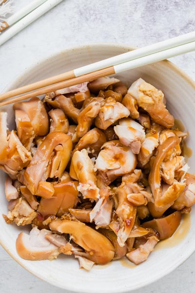 Bowl of chopped shoyu chicken coated in a rich, glossy sauce.