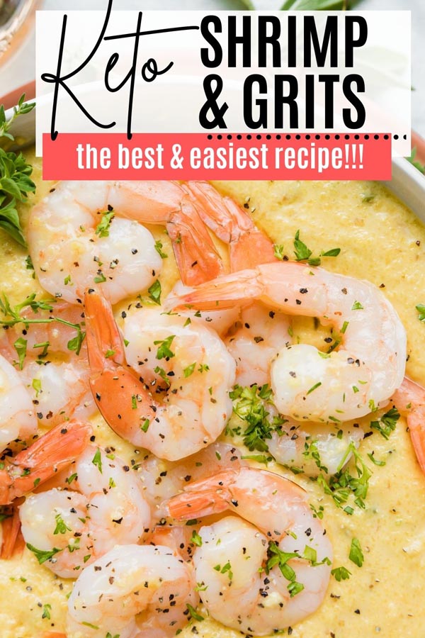 a layer of cooked shrimp on a pile of grits topped with chopped parsely
