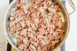 ground beef and sausage cooking in a skillet