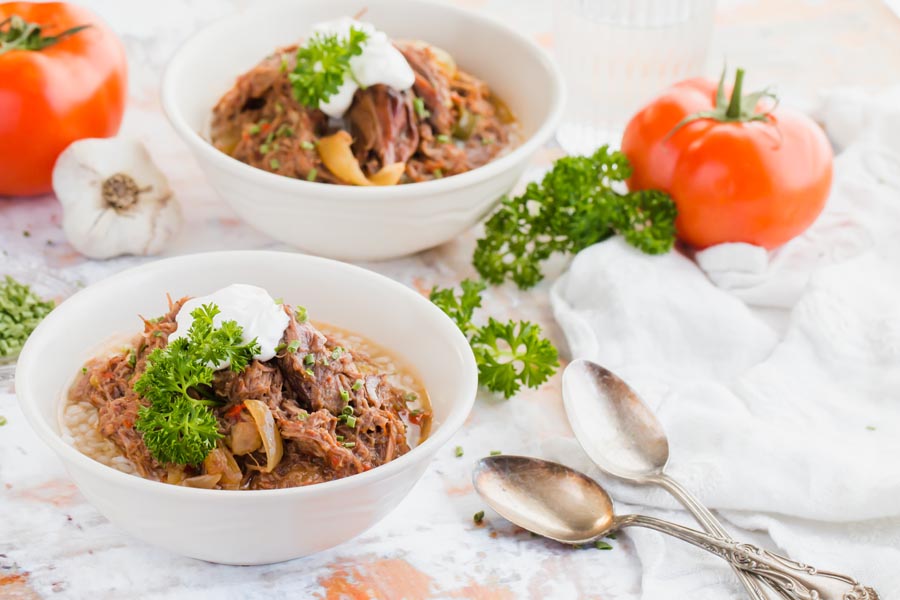 two bowls of shredded beef steak with peppers