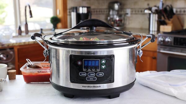 slow cooker with peppers off to the side