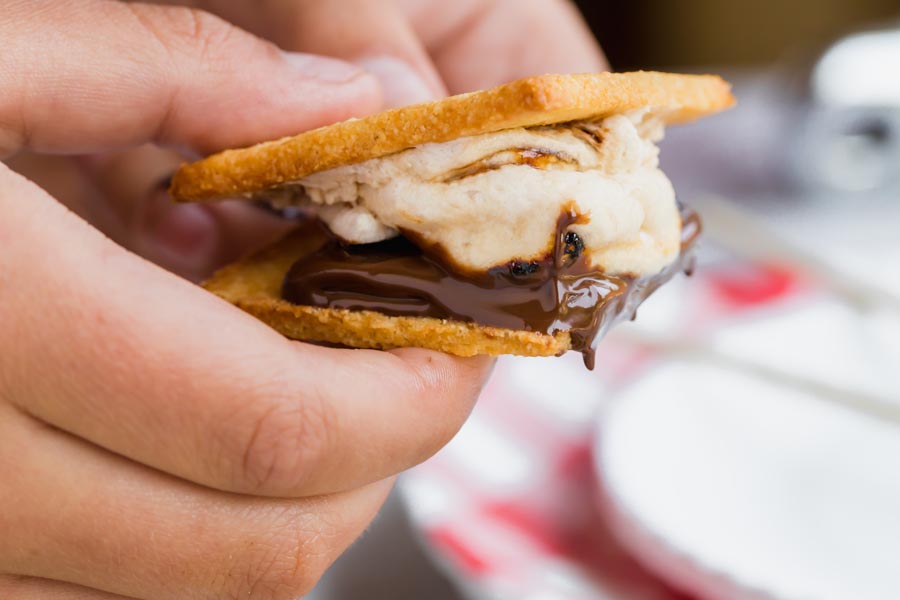holding a smore as chocolate melts down