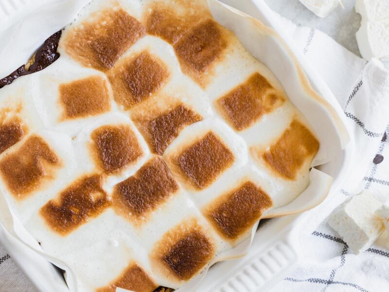 golden brown toasted marshmallows baked in a white baking dish