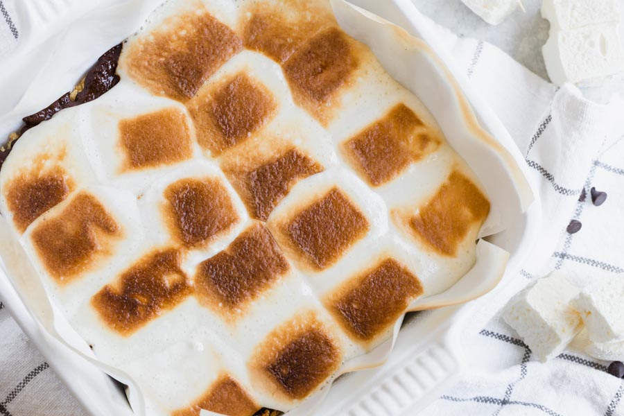 golden brown toasted marshmallows baked in a white baking dish