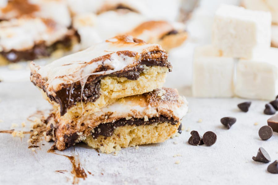 two smores bars stacked on top of each other with chocolate chips scattered