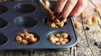 scooping cereal smore mixture into a muffin tin