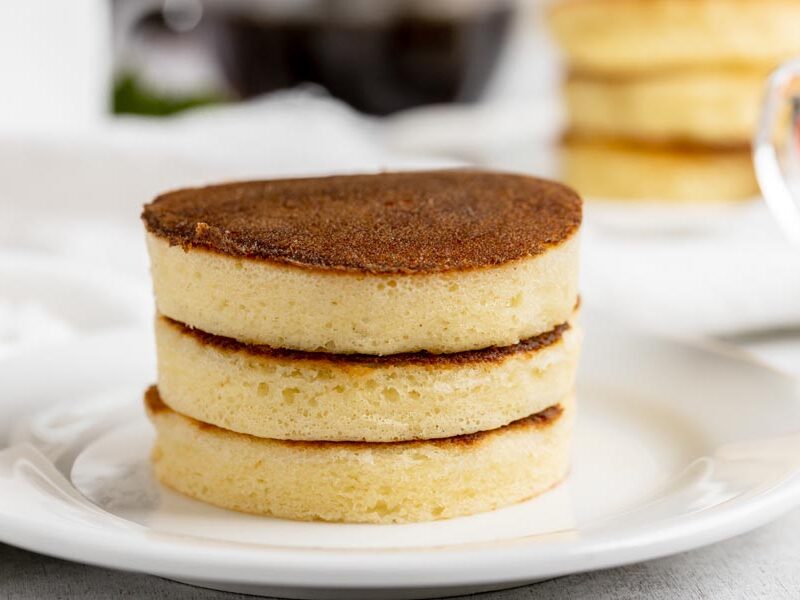 three thick pancakes stacked on top each other on a plate