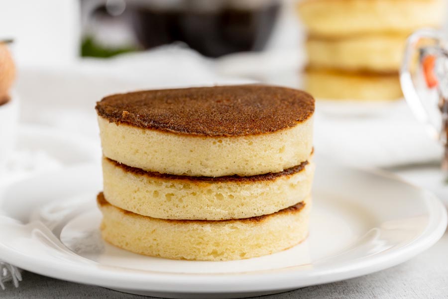 three thick pancakes stacked on top each other on a plate