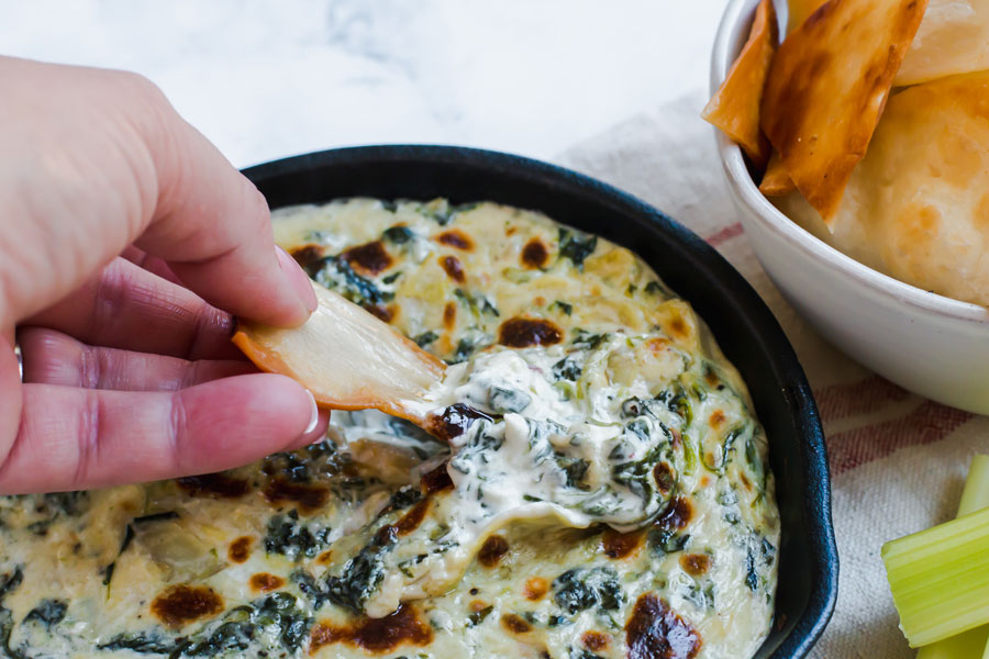 chip in cheesy artichoke dip