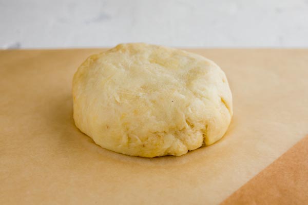 ball of fathead dough on a piece of parchment paper