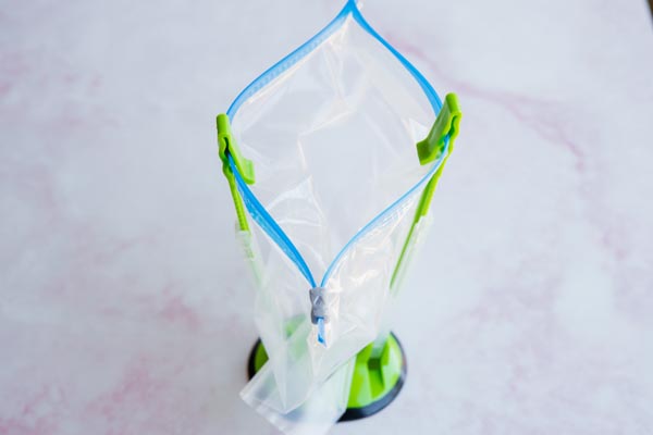freezer bag holders holding up a plastic baggie
