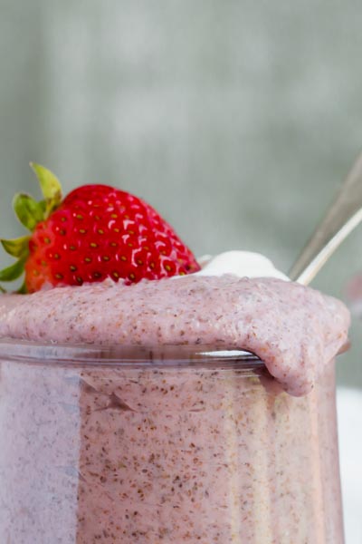 thick chia pudding dripping down the edge of a small mason jar