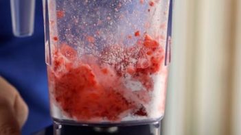 strawberry pureeing in a blender