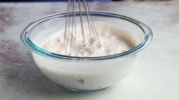 whisking heavy cream in a bowl