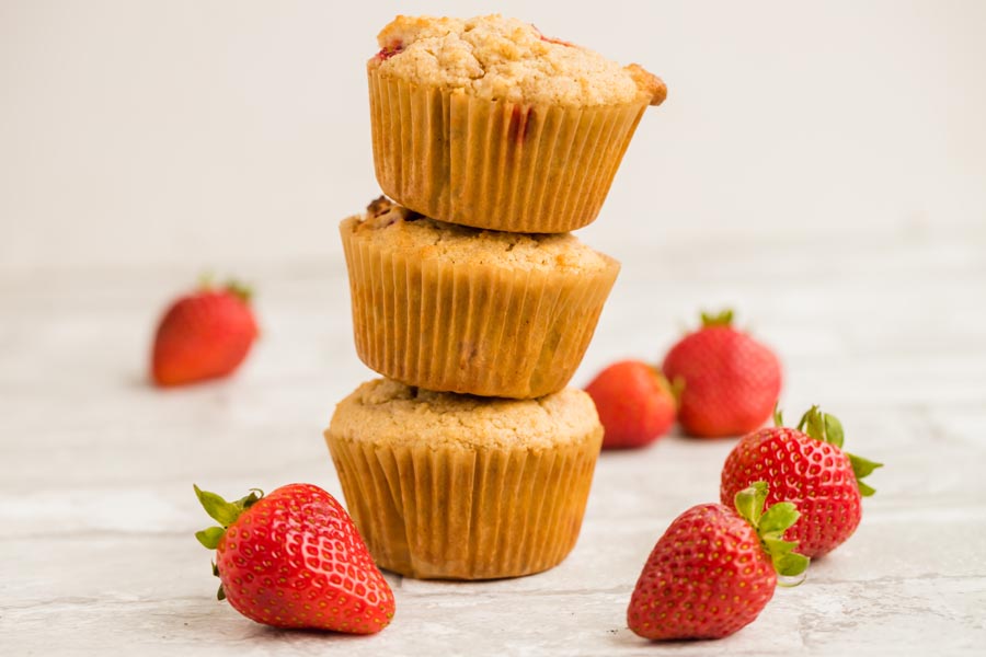 stack of muffins with strawberries around
