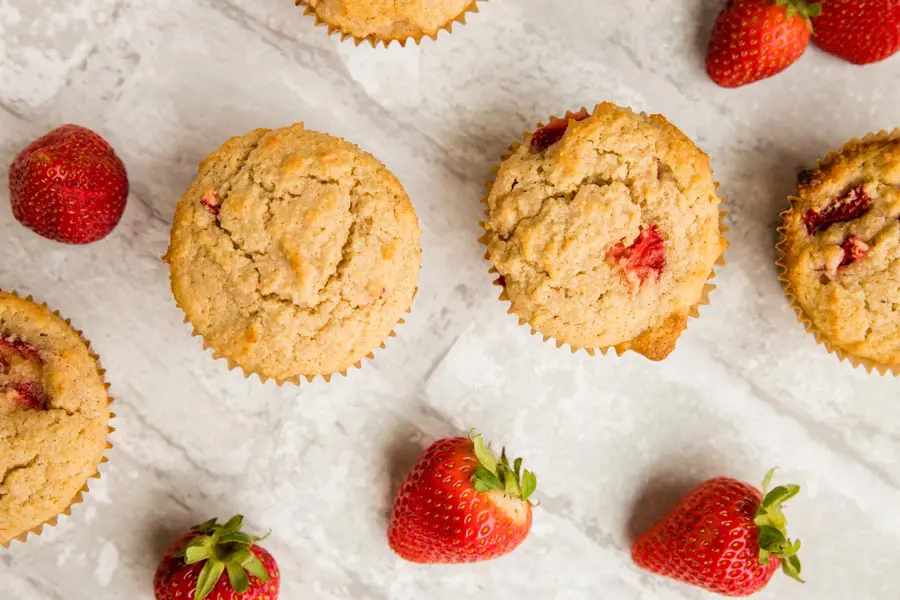 top down view of muffin tops and berries around