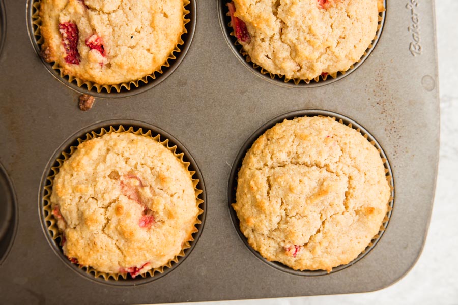 a bunch of muffins on a white counter with full strawberries lying around(/assets/img/recipes/keto-strawberry-muffins-batch.jpg){: .d-block .img-fluid .w-66 .mx-auto}
Almond Flour Keto Muffins
This keto muffin recipe is made using almond flour instead of coconut flour. Many people don’t like the flour of coconut flour so I decided to develop a recipe only used almond flour. It is one of my favorite keto flours to bake with because it yields a delicate, fine crumb texture in muffins and other baked keto treats.
![four almond flour based muffins sitting in a big muffin tin