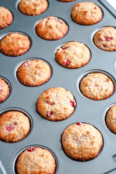 A baking tray filled with strawberry muffins.