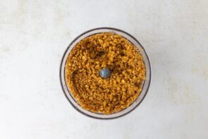 Crushed keto pretzels blended with butter and sweetener in a food processor.