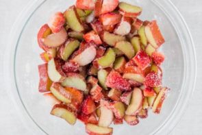 chopped strawberries and rhubarb in a bowl with sweetener