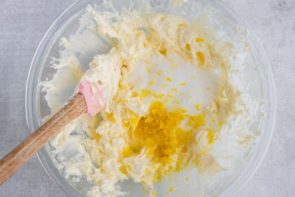 sweetener and lemon zest sitting on top of whipped butter in a bowl