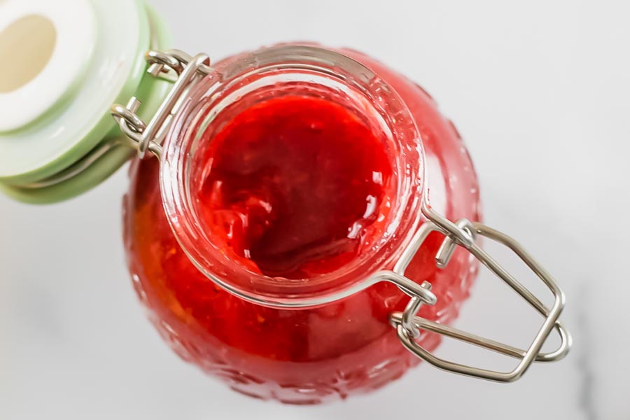 looking in a jar with thick red syrup in it