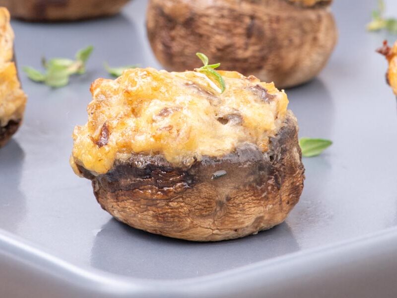 Close up of a juicy cheese and sausage stuffed mushroom.