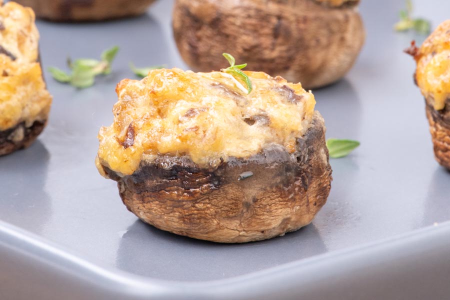 Close up of a juicy cheese and sausage stuffed mushroom.