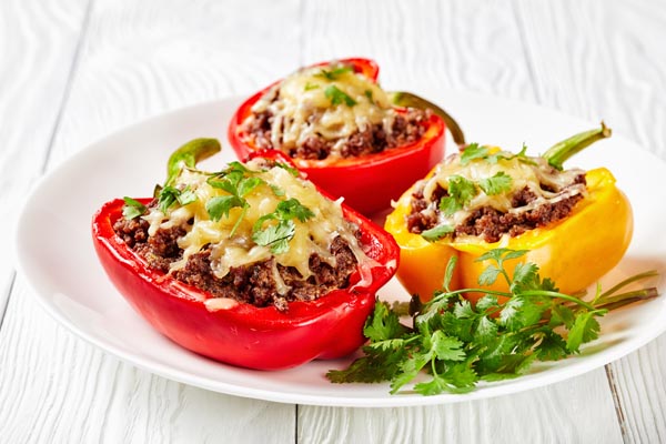 stuffed peppers on a plate with cilantro