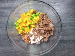 ground beef, diced peppers in a mixing bowl