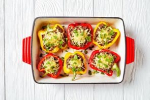 six stuffed peppers in a casserole dish